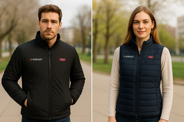 Side-by-side comparison of a heated jacket and heated vest worn by two people.