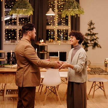 a women are giving a gift to her husband